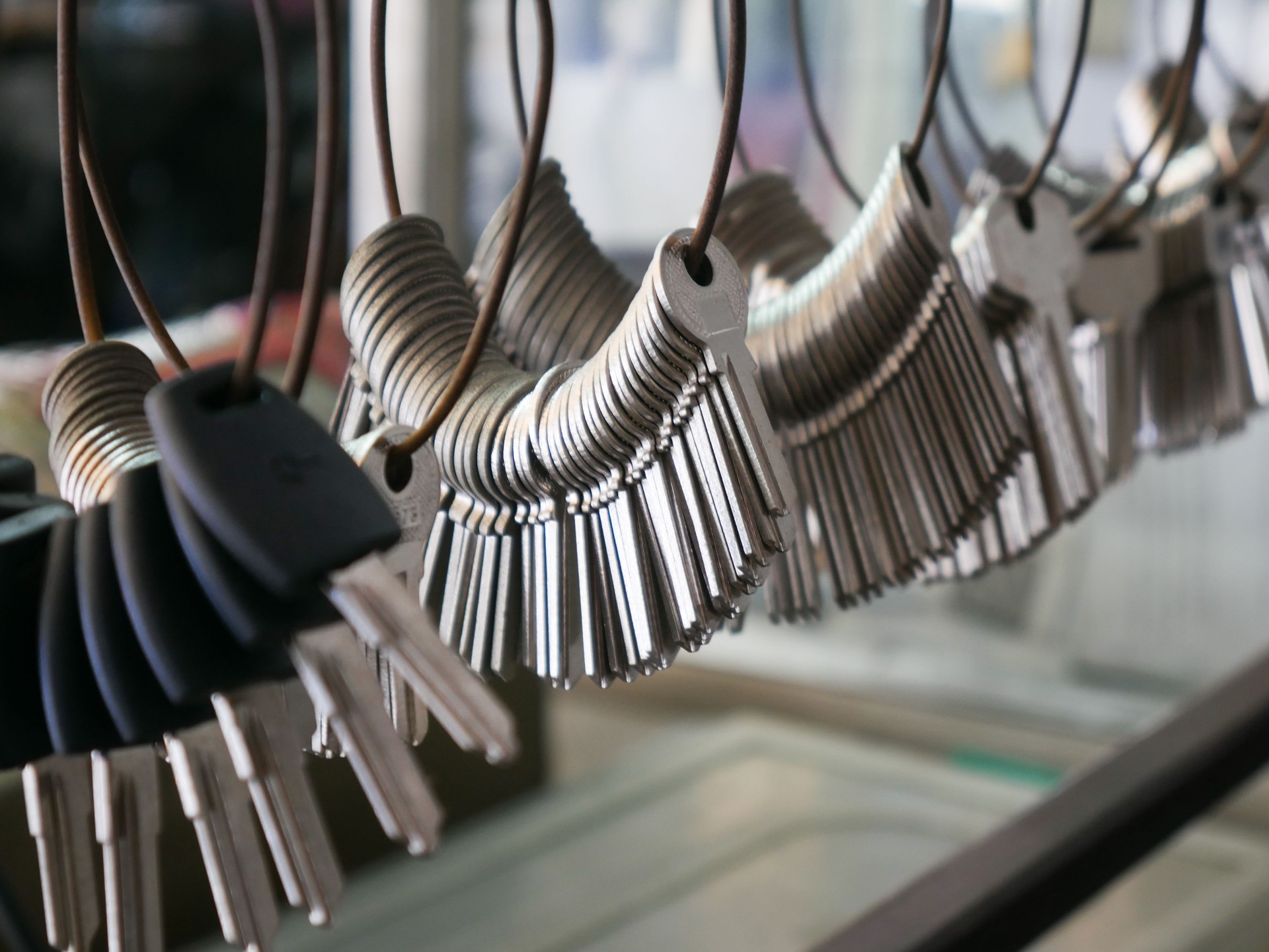 Multiple Duplicate Keys Hanging on Wire Rings at Locksmith Shop - Key Cutting and Duplication Service Business